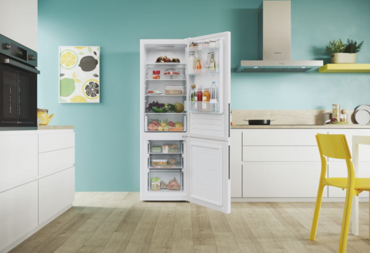 Στην εικόνα απεικονίζεται ο ψυγειοκαταψύκτης Candy CCT3L517EW σε λευκό φόντο με ανοιχτές πόρτες και γεμάτο με τρόφιμα.